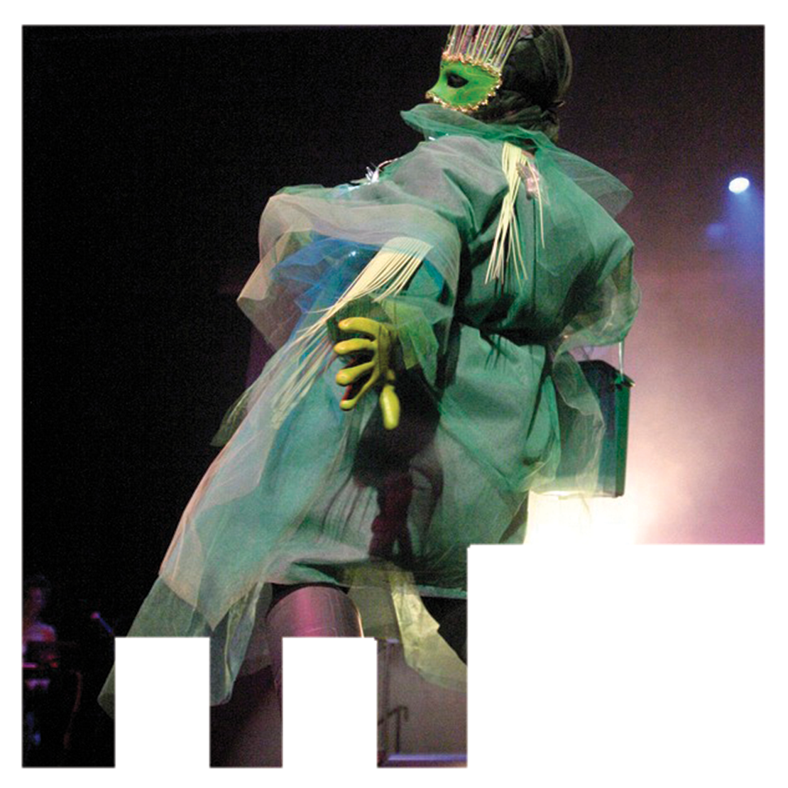 A model at the Wearable Artshow in a ruffled green sheer robe with matching mask and gloves.