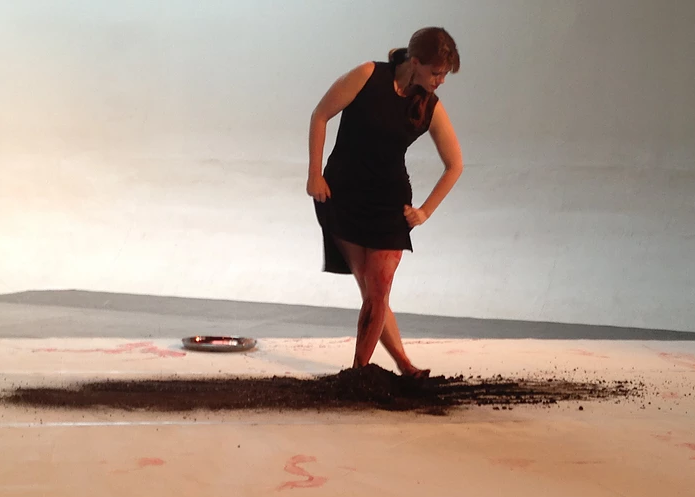 Photo of Brandy Leary dancing in the sand