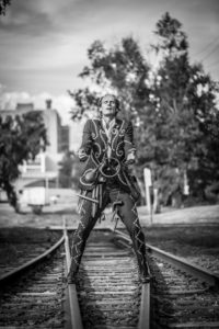 Bill Coleman performing on train tracks.