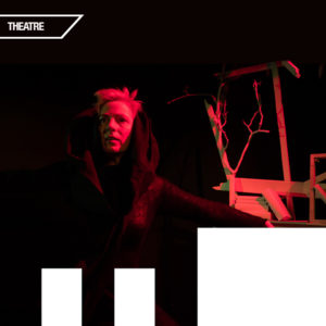 Image of individual looking into distance standing next to precarious looking shelving. Background is black and lighting on individual and shelving is red. Upper left corner reads "theatre".