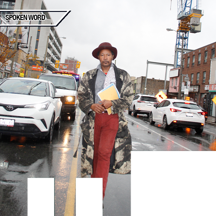 A celebratory CD Launch for clifton joseph Man in hat, red pants, and long patterned coat holding papers walks in the middle of a busy street next to cars and buildings. Upper left corner says 